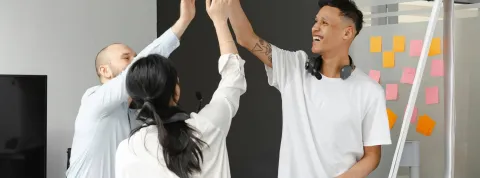 unos compañeros de trabajo se están chocando la mano