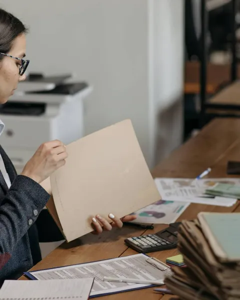 Una empresaria están haciendo leyendo informes en su despacho