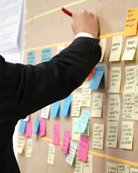 Un trabajador está escribiendo en diferentes post it